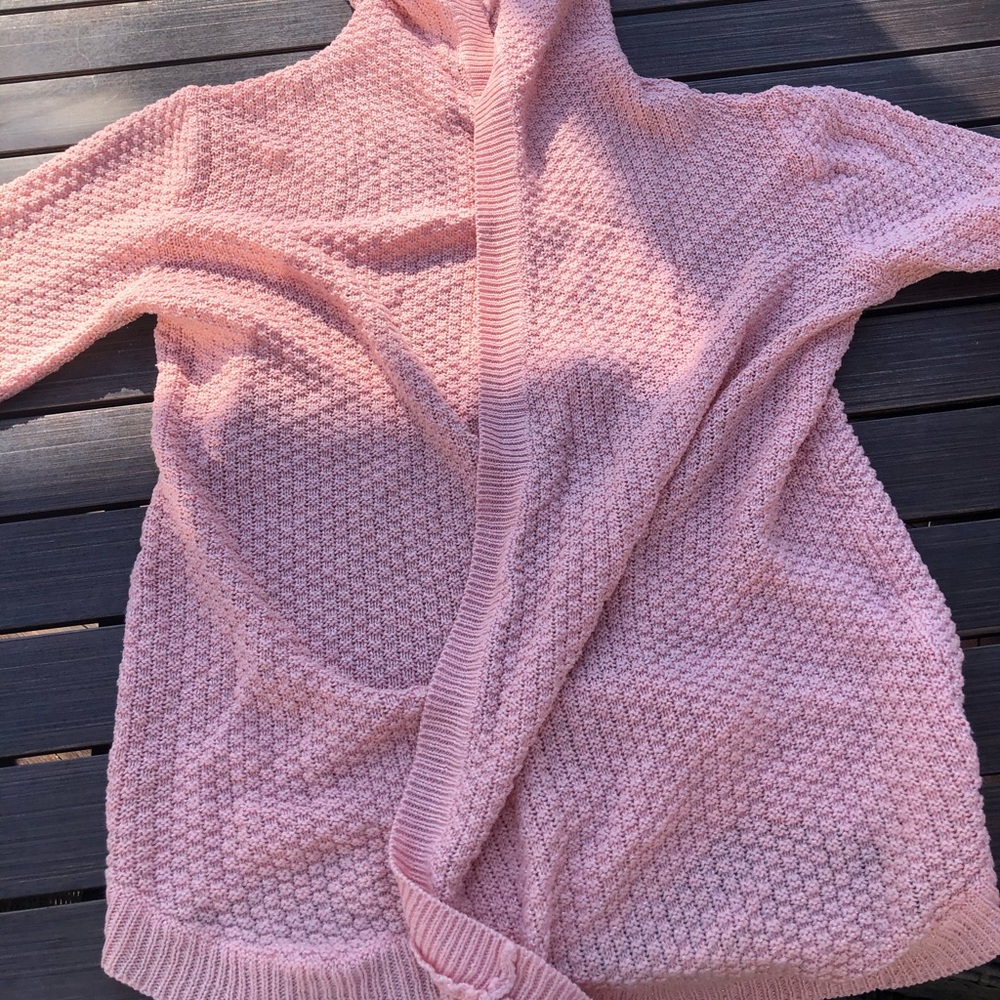 A pink sweater with mini sparkles in the stitching